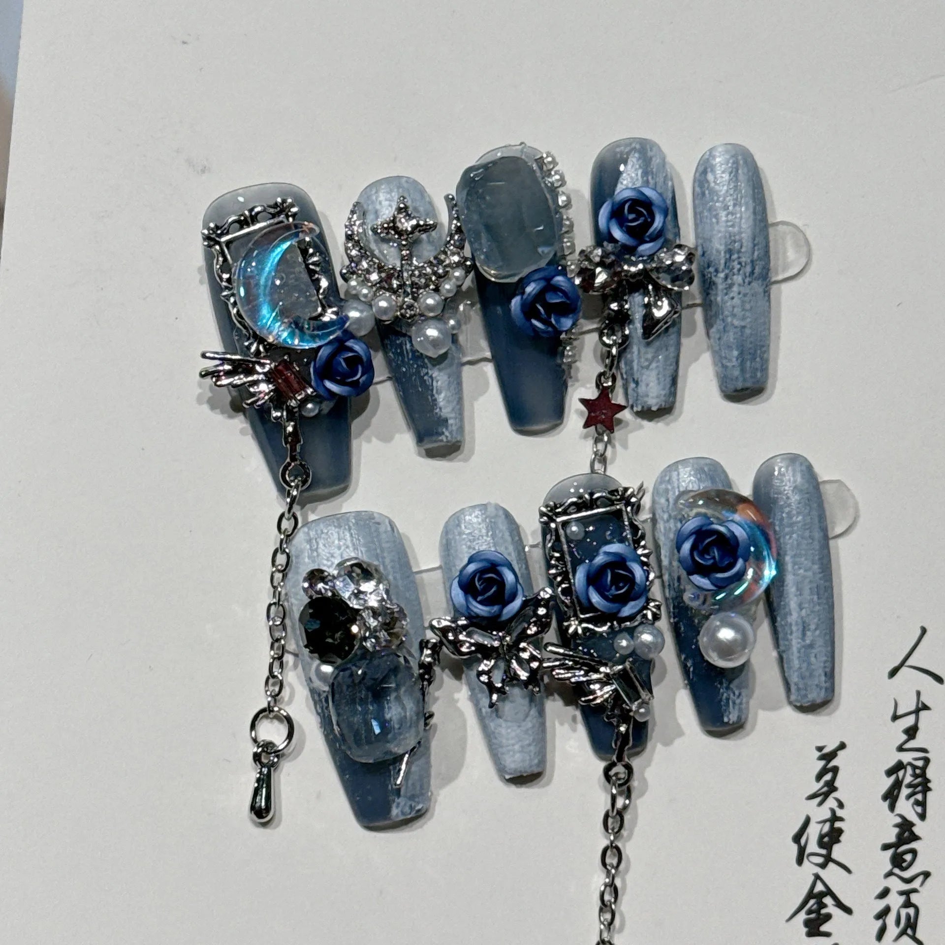 False nails with rose floral patterns in night blue colour, size options displayed