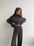 Women's acrylic suit with side-slit sweater top and matching trousers in solid colour