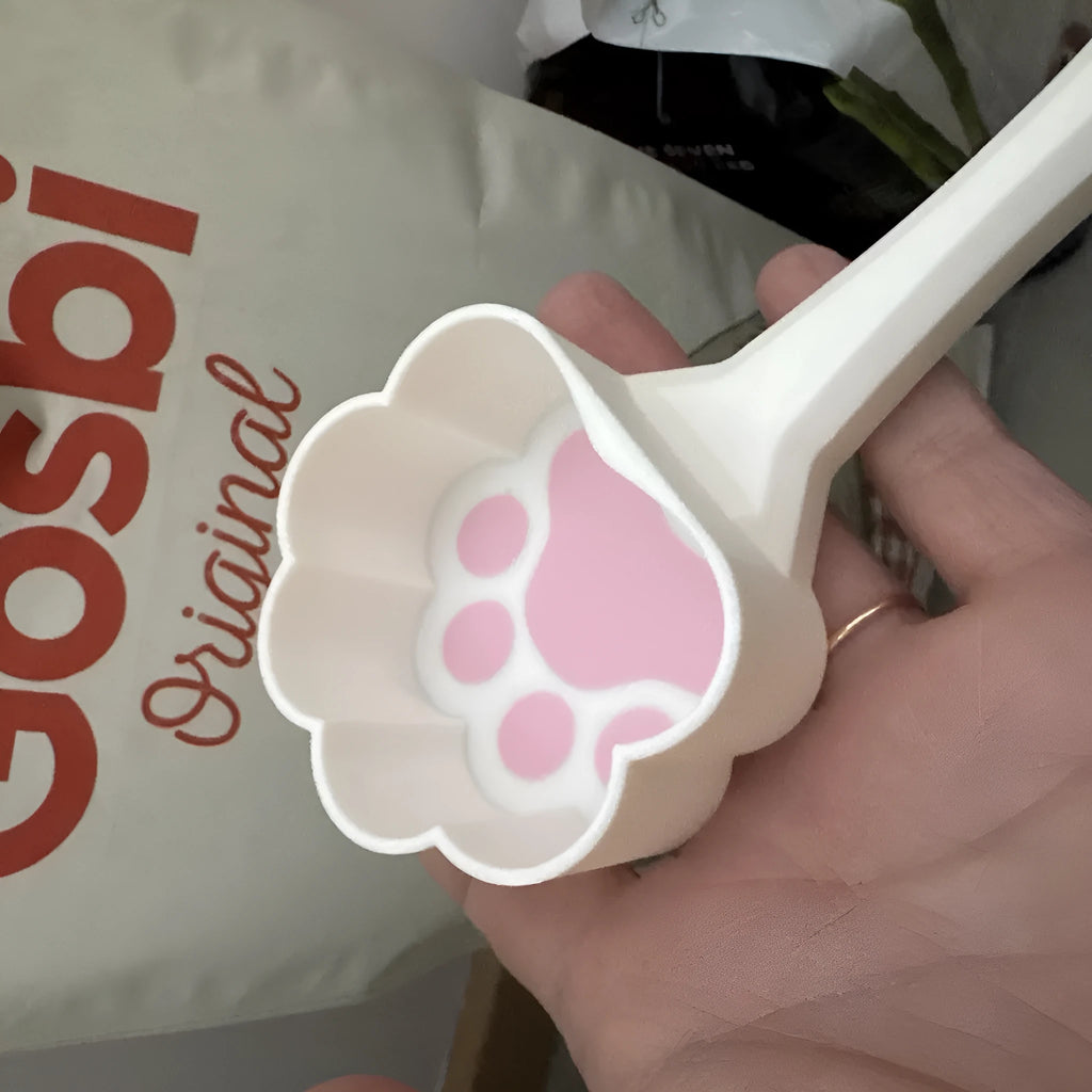 PLA cat paw pet food scoop in white and blue colour on surface