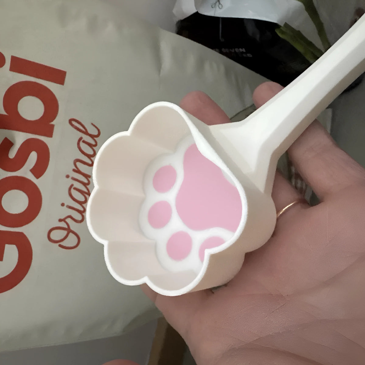 PLA cat paw pet food scoop in white and blue colour on surface