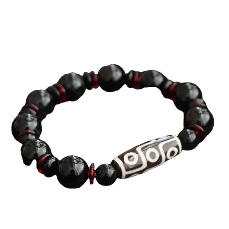 Black agate dzi bead bracelet with hand-woven construction and geometric 11mm beads