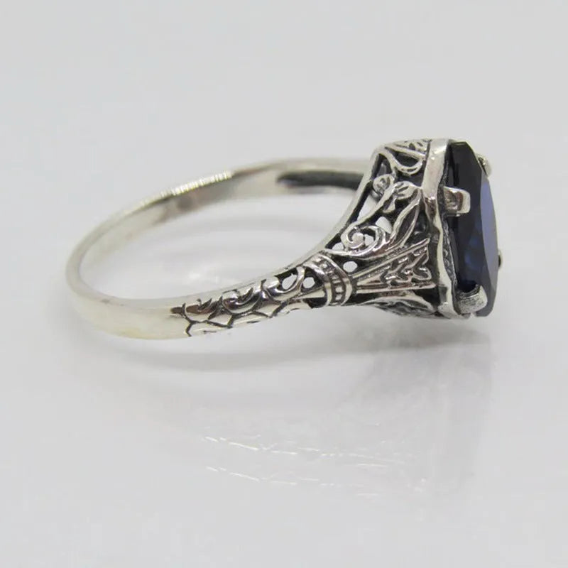 Women's silver alloy ring with geometric hollow pattern and zircon detailing