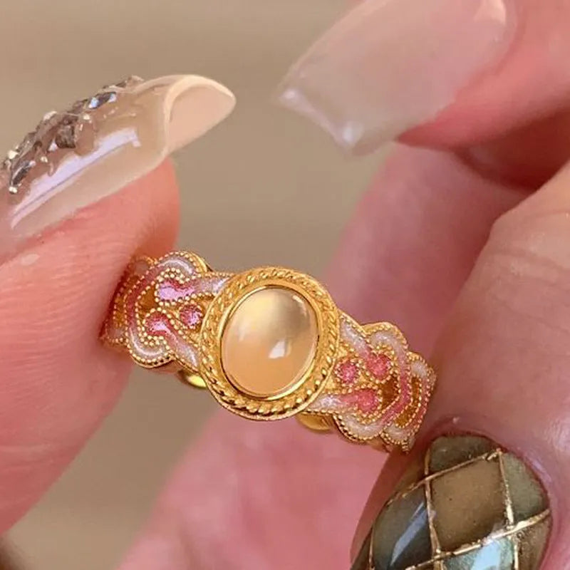 Pink crystal enamel geometric open mouth ring for women on gold-plated copper band.