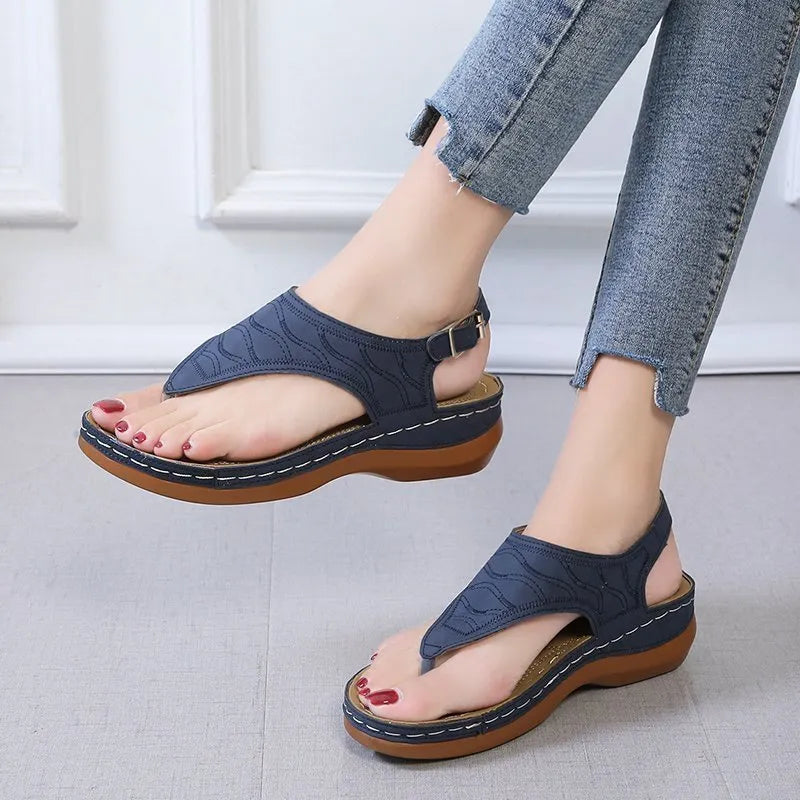 Women's wedge heel sandals with an adjustable buckle strap in a solid colour