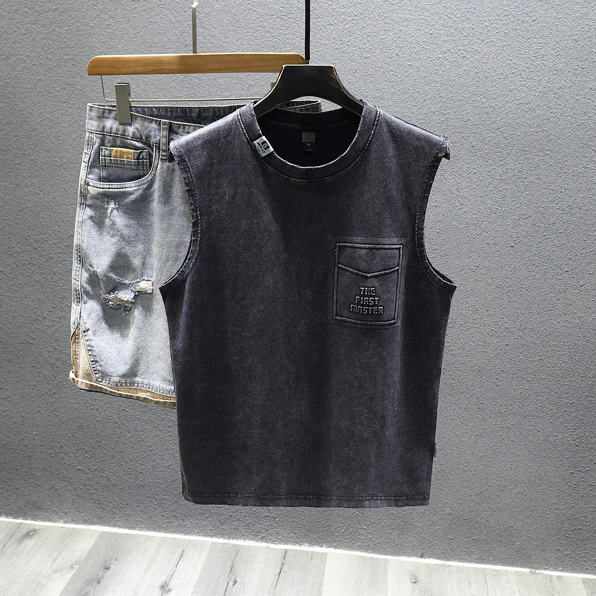 A solid colour loose cotton sleeveless t-shirt on a hanger, shown in white and black.