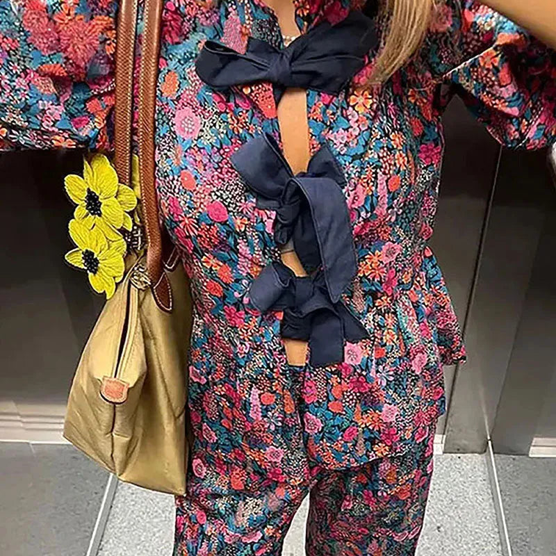 Women's floral print trouser suit with puff sleeve blouse and matching trousers