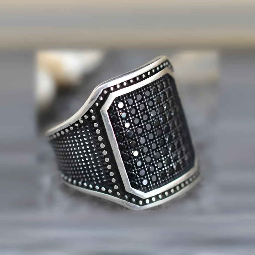 Black alloy ring with copper-inlaid zircon detail showing European and American jewellery style