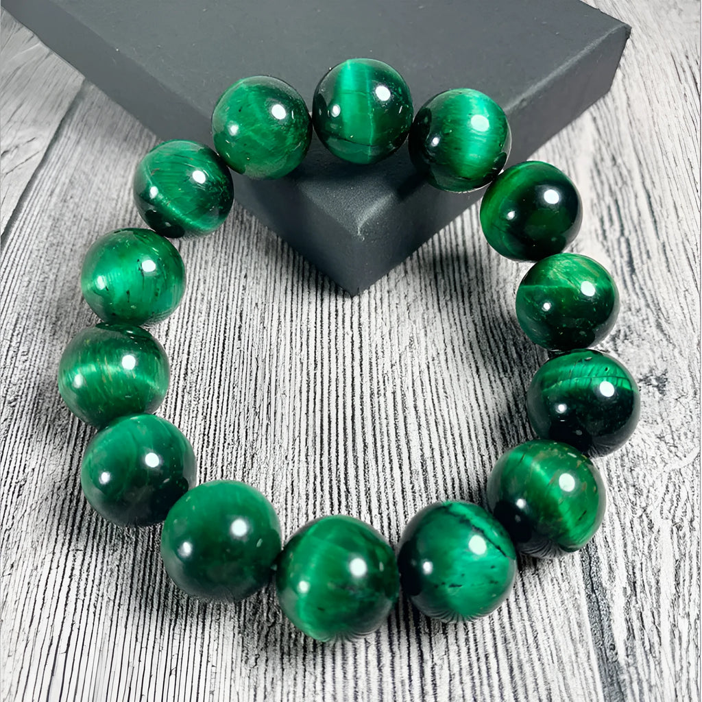 A green tiger eye stone beaded bracelet with geometric polished beads on an adjustable cord.