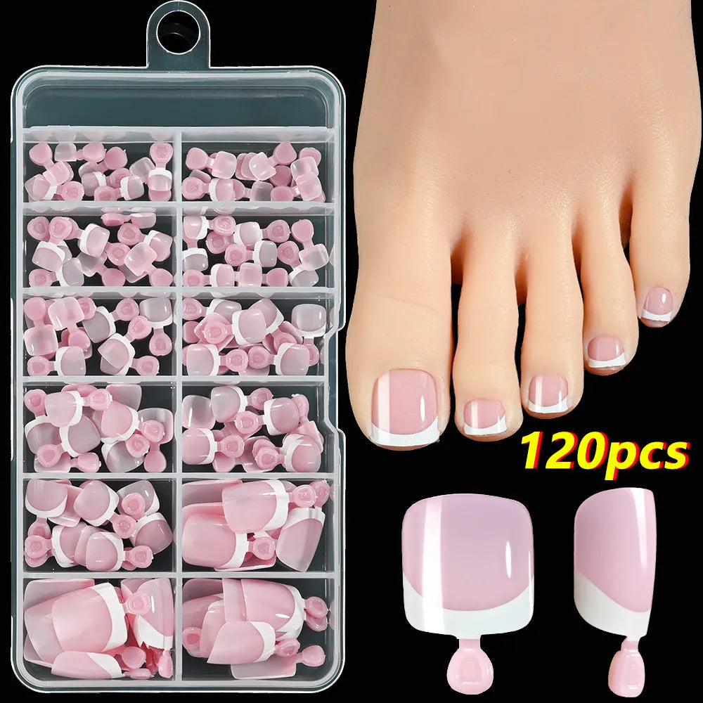 Box of 120 short square false toenails with French white tip design on nude base.