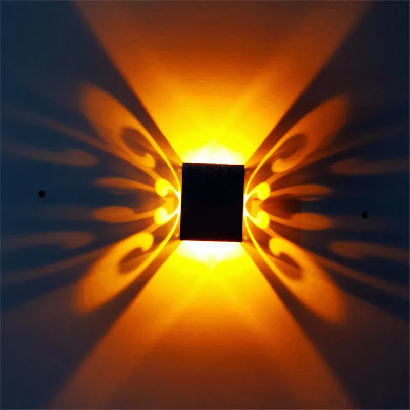 Modern aluminium butterfly-shaped LED wall lamp with multi-colour remote control.