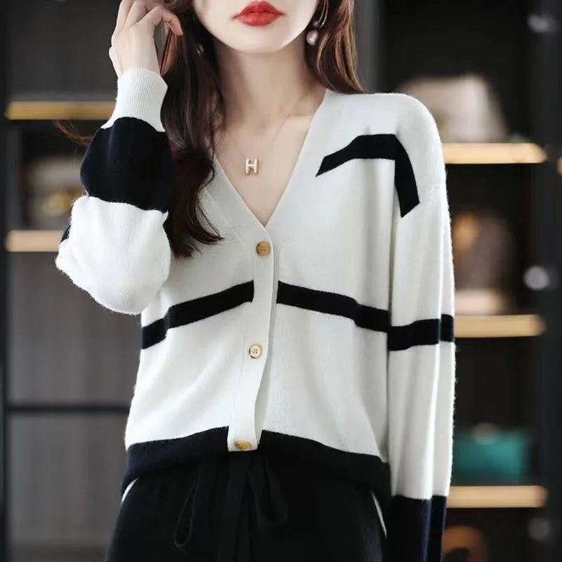 Women's black and white striped knitted cardigan with 3D pattern, V-neck, and button-up front.