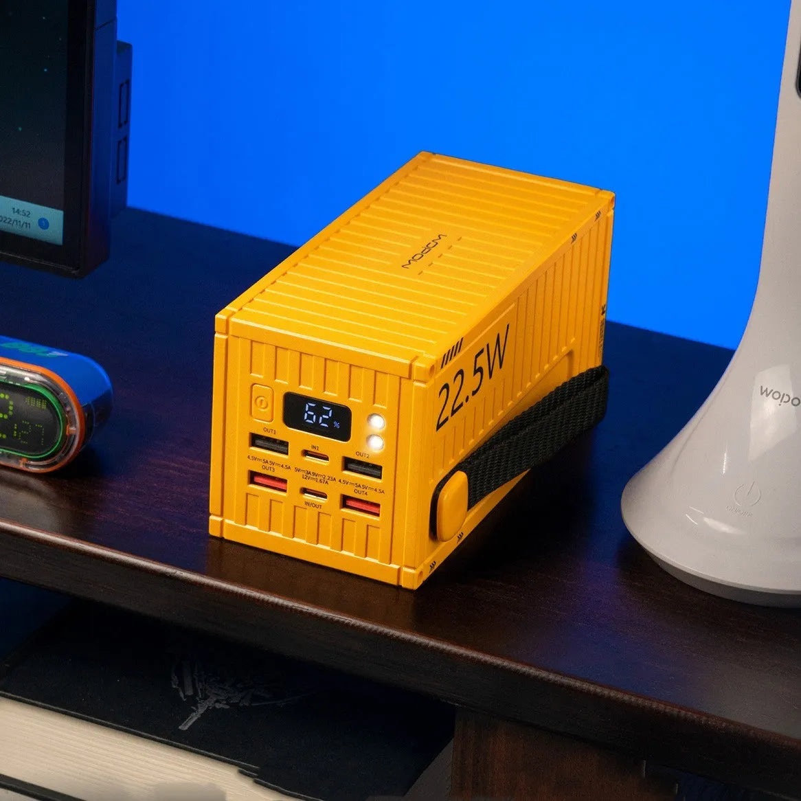 Yellow 50000mAh portable power bank with digital display showing battery percentage and five output ports.