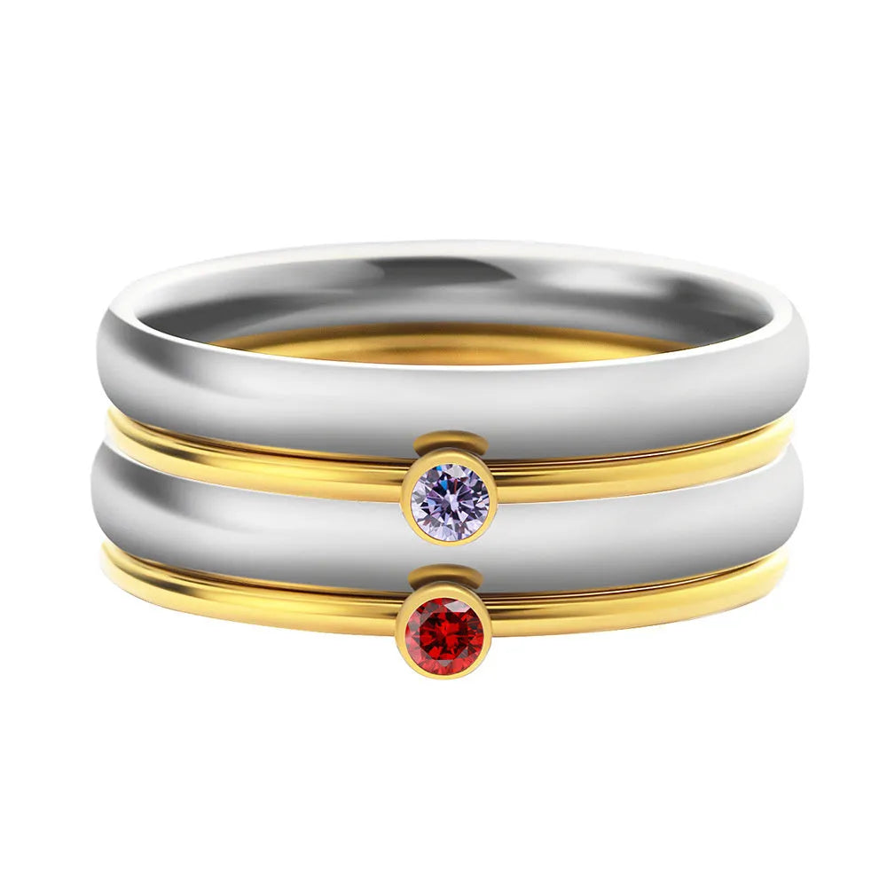 Engraved geometric titanium steel ring with December birthstone colour and layered design on a grey background