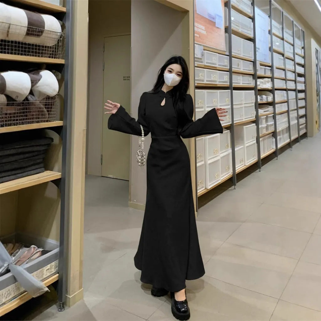 Plus size cheongsam dress in black with waist-tight draping effect and long sleeves