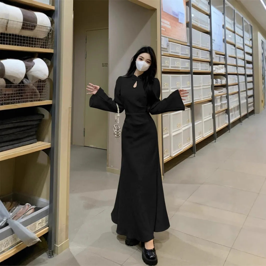 Plus size cheongsam dress in black with waist-tight draping effect and long sleeves