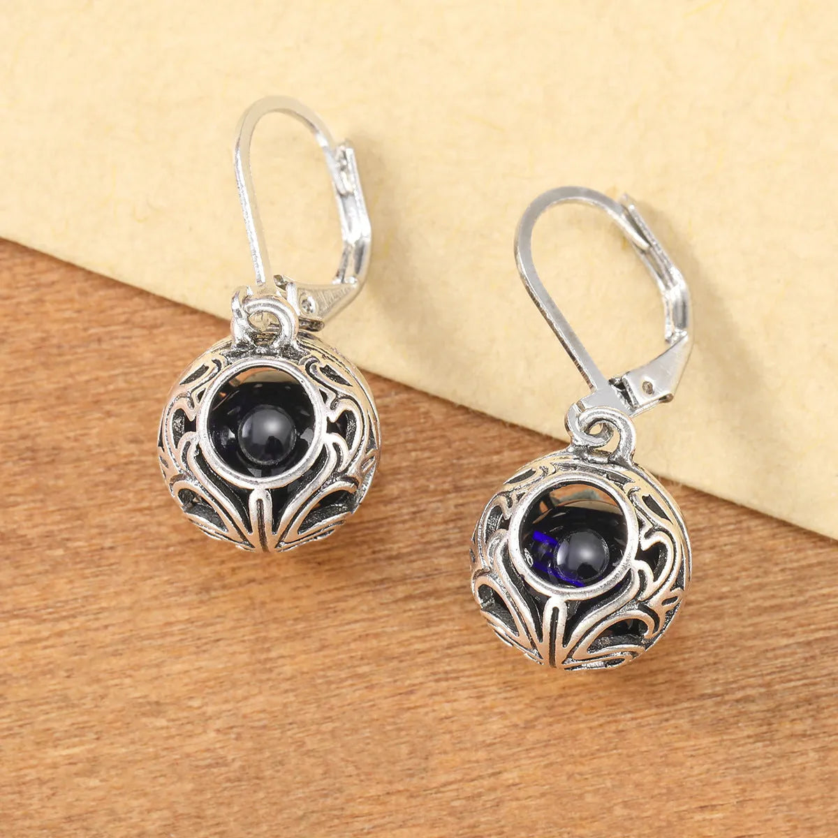 Women's silver geometric hollow pendant earrings with vintage engraving and blue gemstone accents