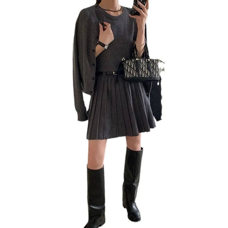 Grey women's art retro knit two-piece set featuring a pleated vest skirt with belt and a long-sleeved cardigan.