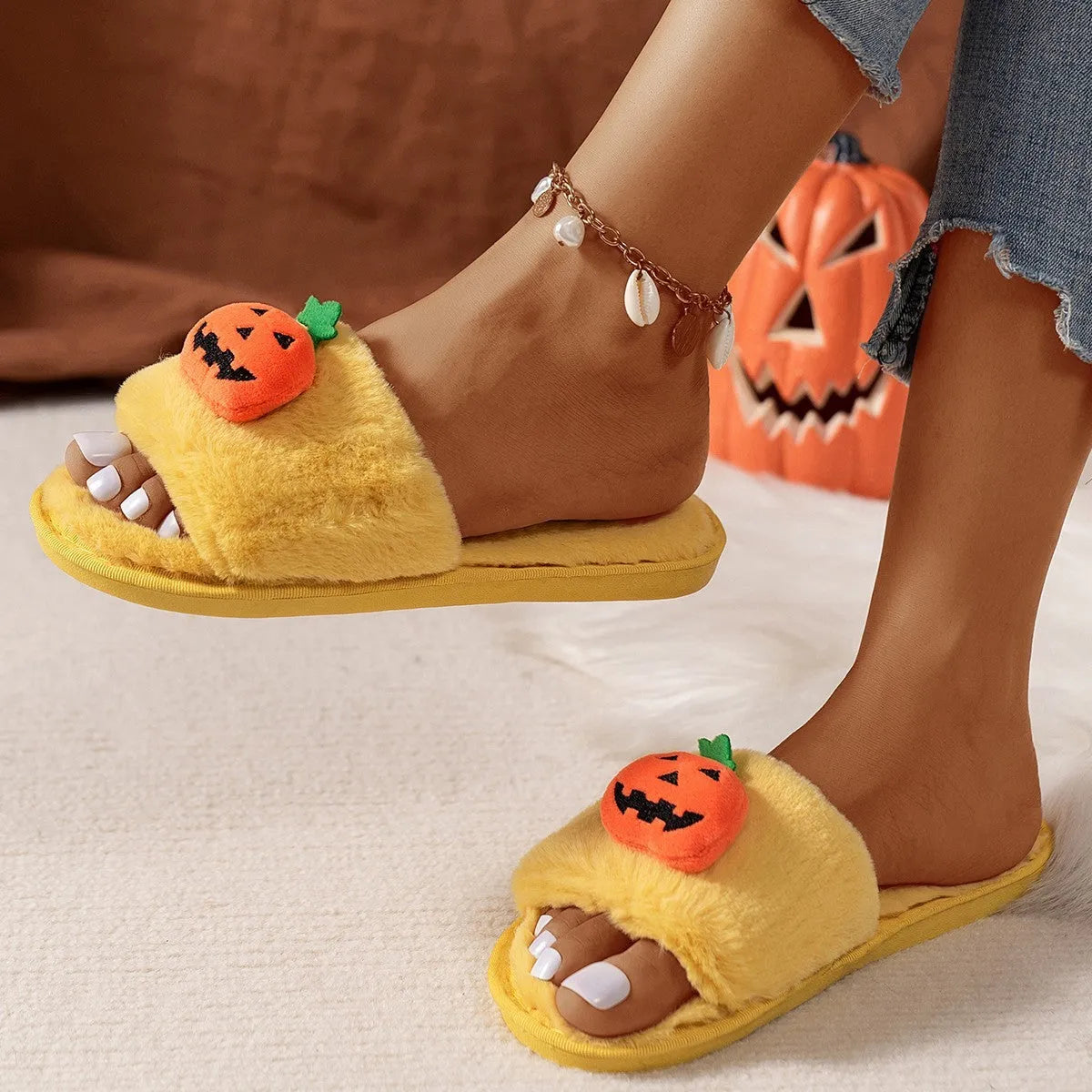 White and yellow Halloween pumpkin plush open toe slippers with synthetic fur and PVC sole.