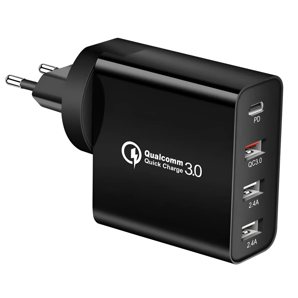 White multi-port fast charging adapter with UK plug on a table.