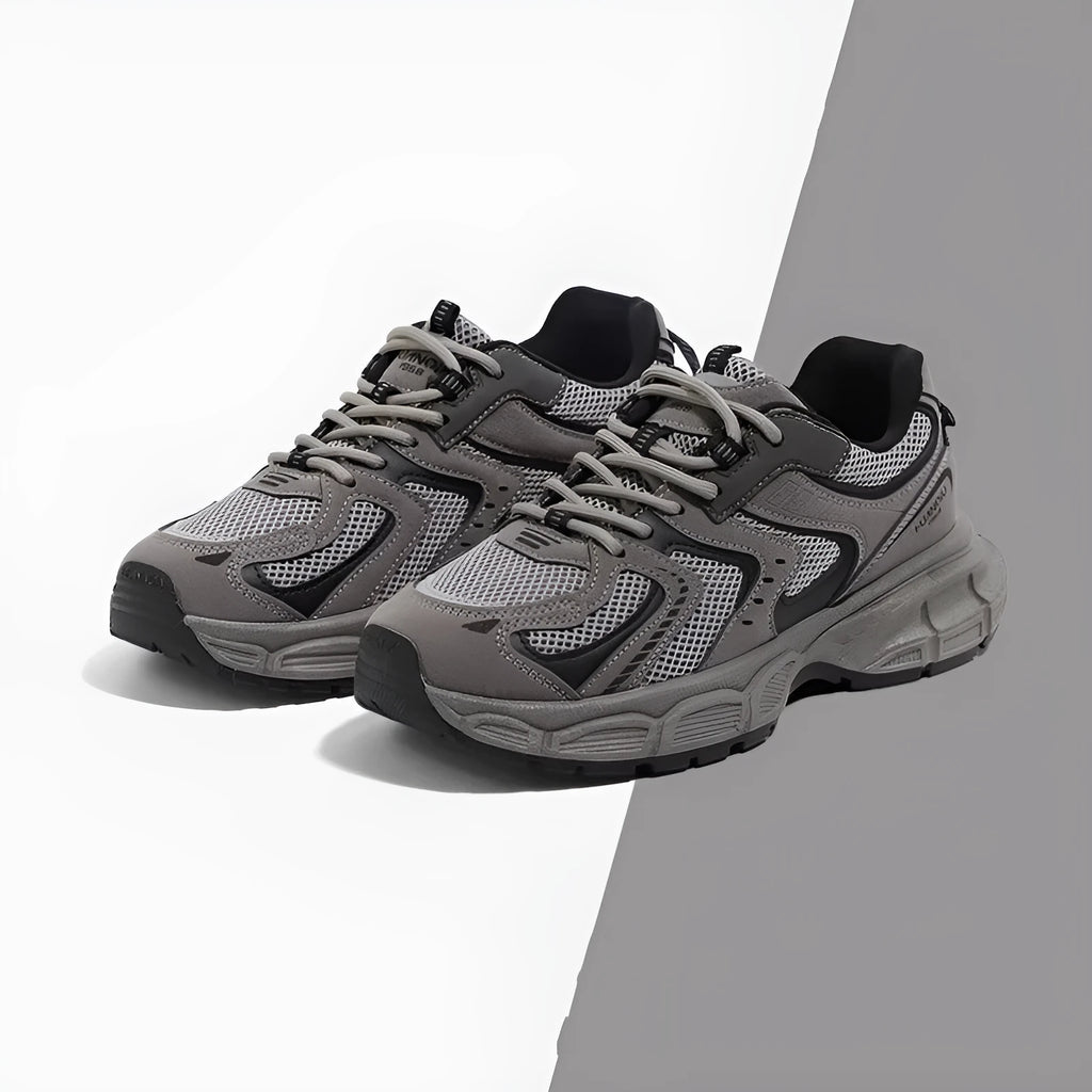 Grey low-top casual sneaker with PU mesh upper, round toe, lace-up front, and a flat EVA sole on a neutral background.