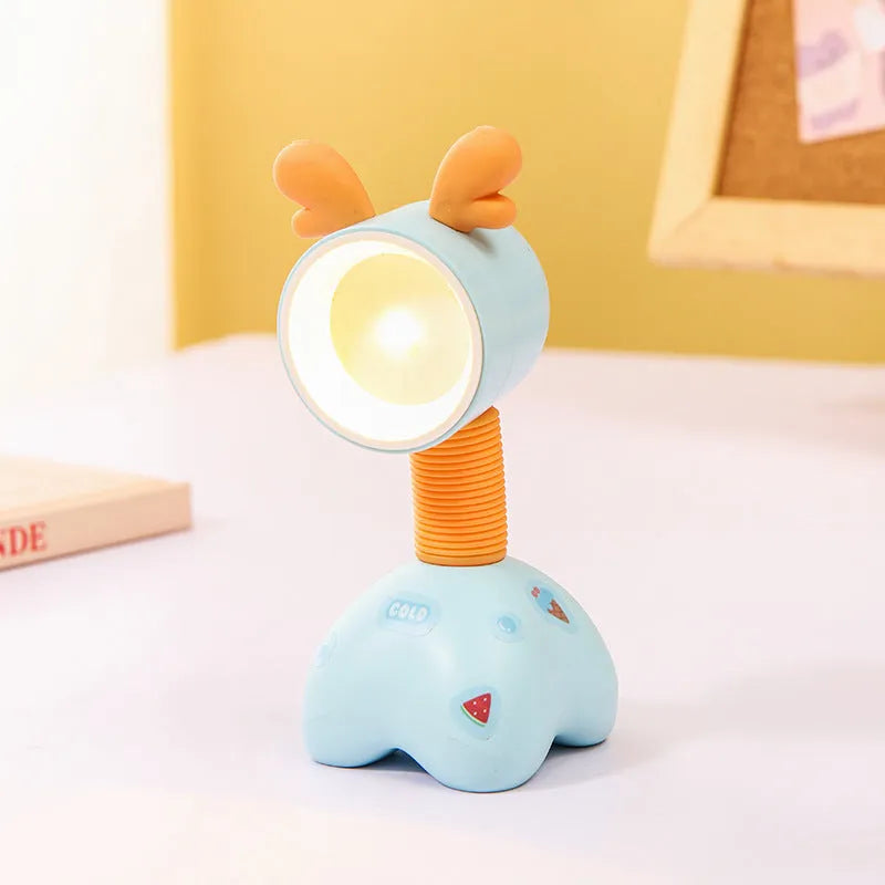 Small plastic cartoon animal night lamp with a magnetic adjustable base on a desk.