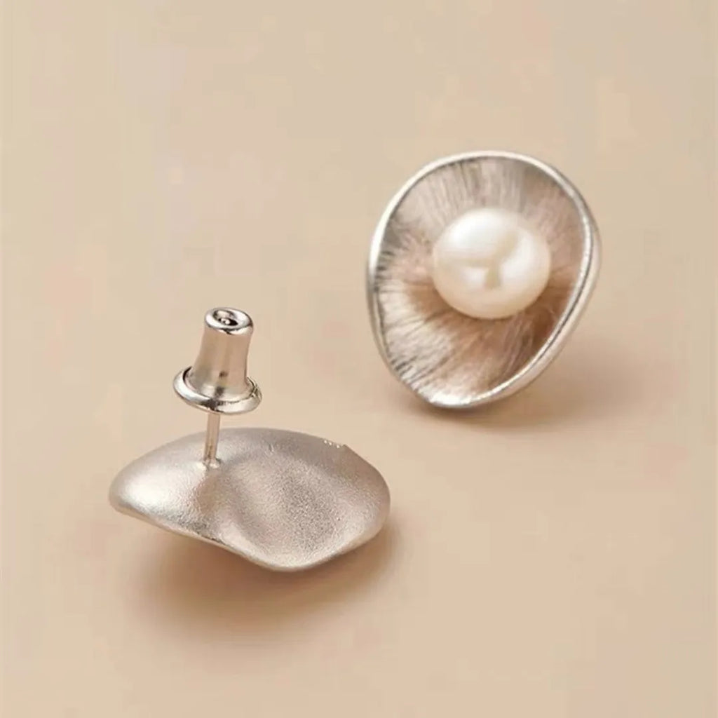 Pearl sterling silver needle earrings with gold electroplated finish and geometric design