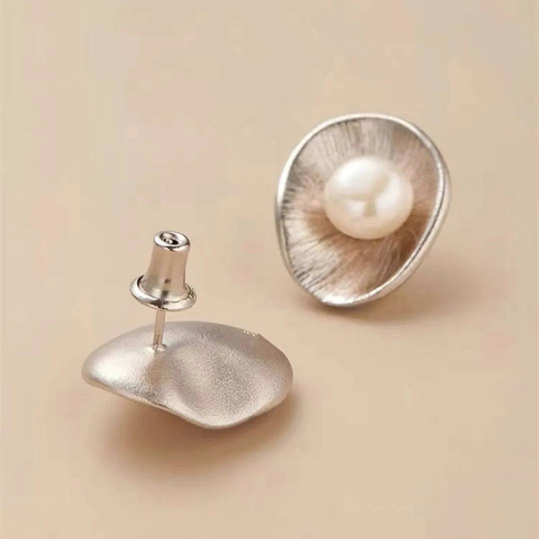 Pearl sterling silver needle earrings with gold electroplated finish and geometric design