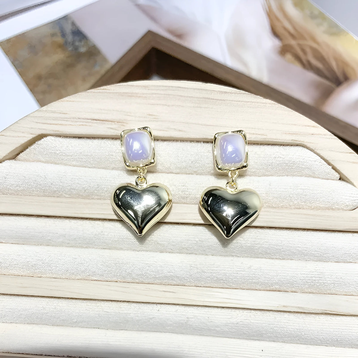 Small gold heart earrings with metal construction and post backing