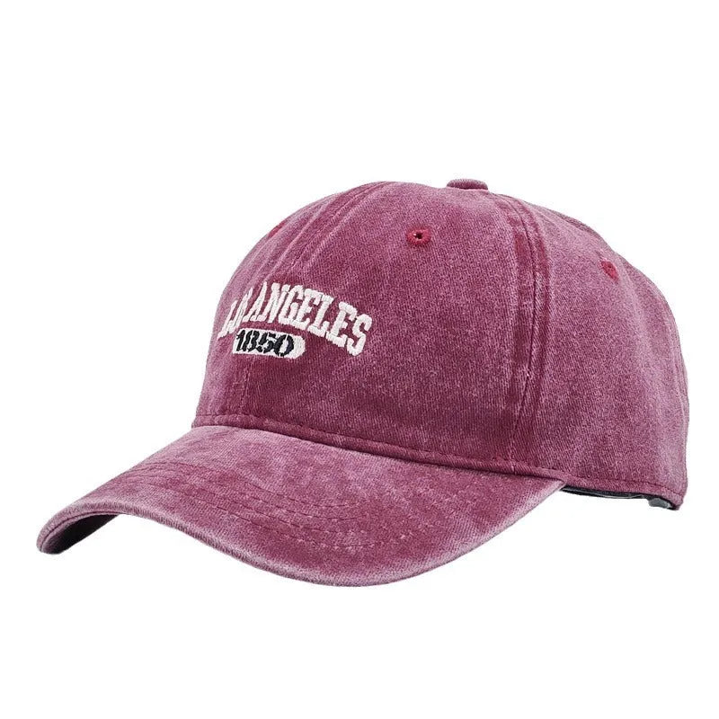 Retro-style adjustable acrylic peaked cap with embroidered letters, shown in a distressed beige colour.