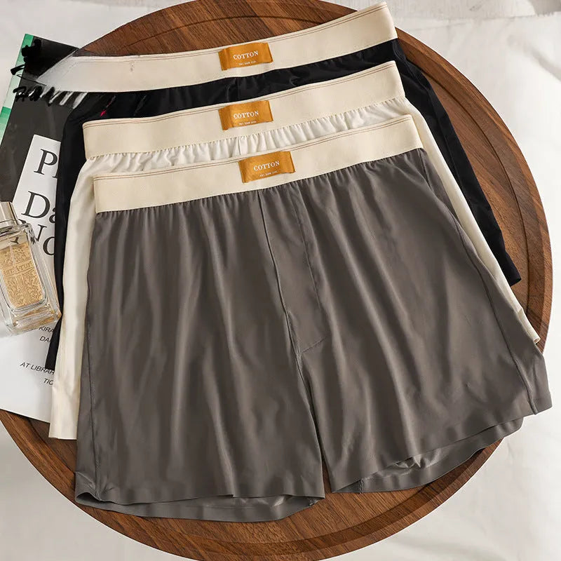 Men's solid colour ice silk loose fit boxer shorts on a white background.