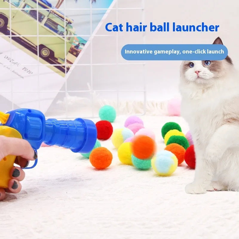 Plush ball launching gun for dogs next to a pile of soft coloured yarn balls.