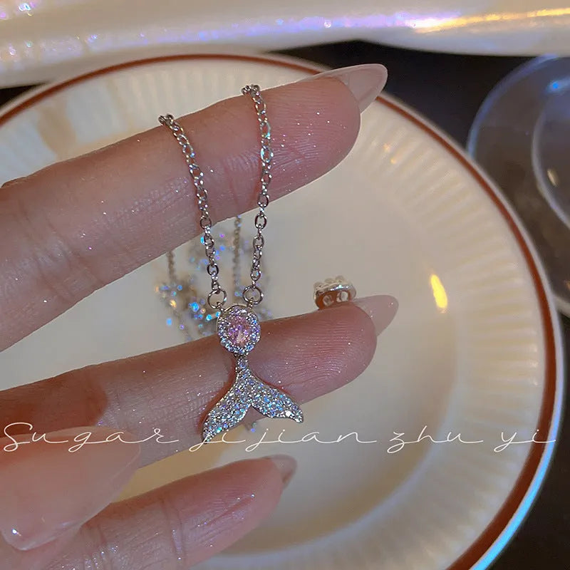 Women's sterling silver necklace with geometric angel wing or fishtail pendant on an O-ring chain.