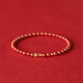 Natural cinnabar koi bracelet with golden ball design in Chinese national style