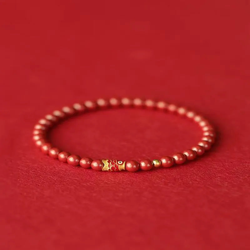 Natural cinnabar koi bracelet with golden ball design in Chinese national style