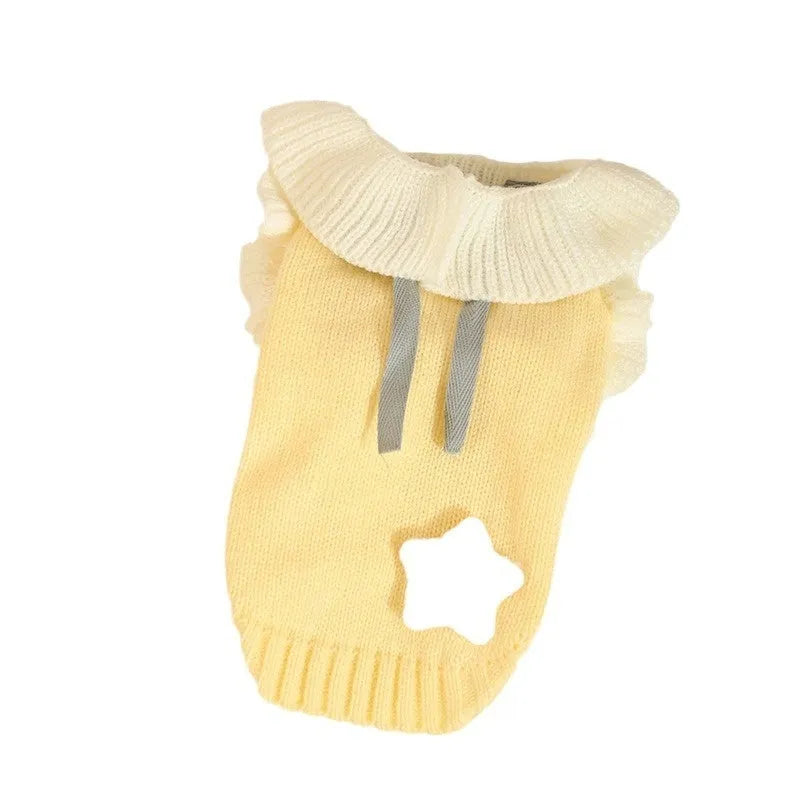 Yellow acrylic dog sweater for a small puppy on an autumn day