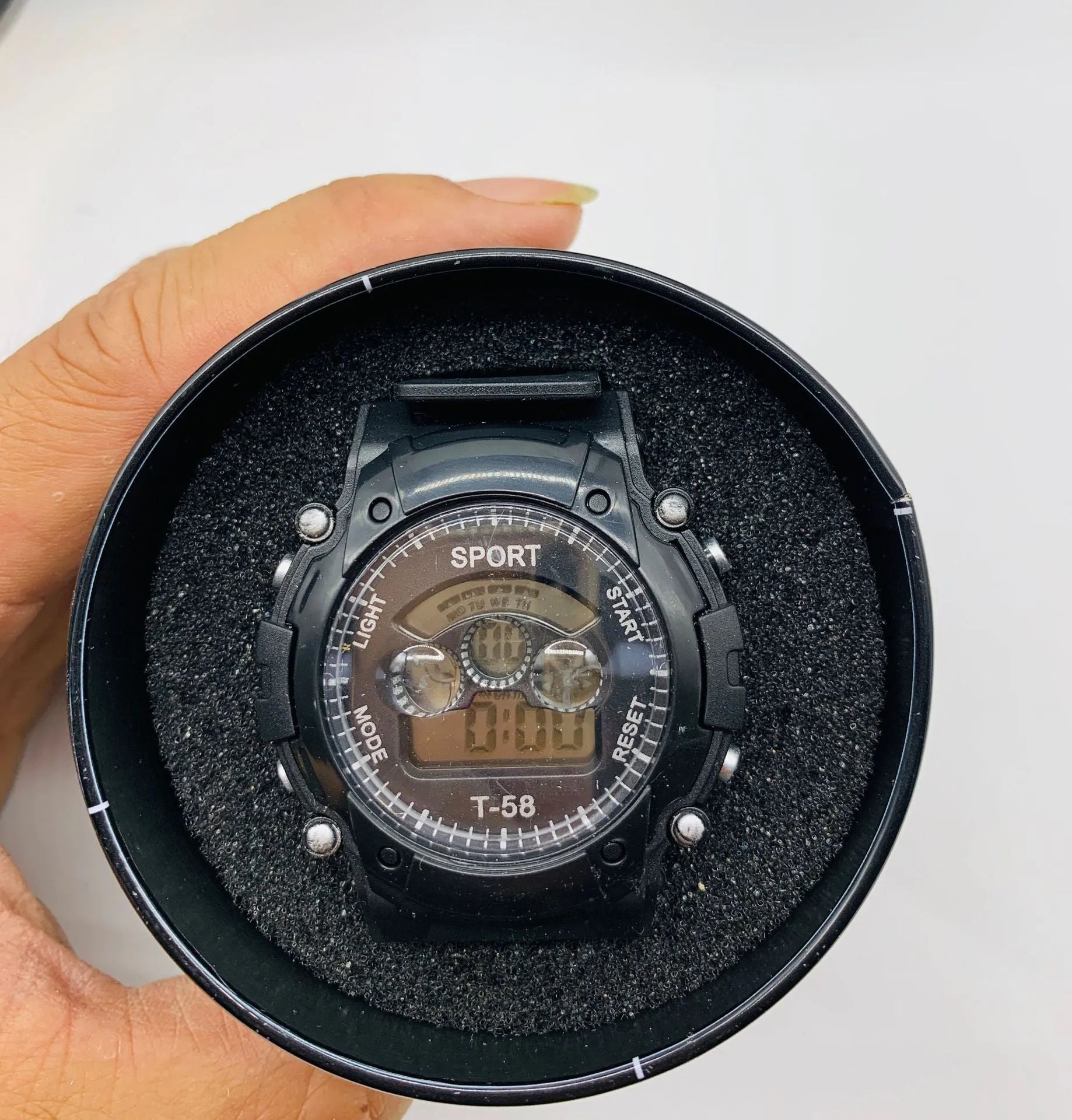 Children's digital sports watch with silicone strap, plastic case, and mixed colour display showing alarm and calendar functions