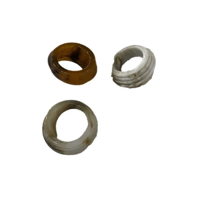 Chinese style irregular geometric resin ring in wide band design showing brown and white colour options