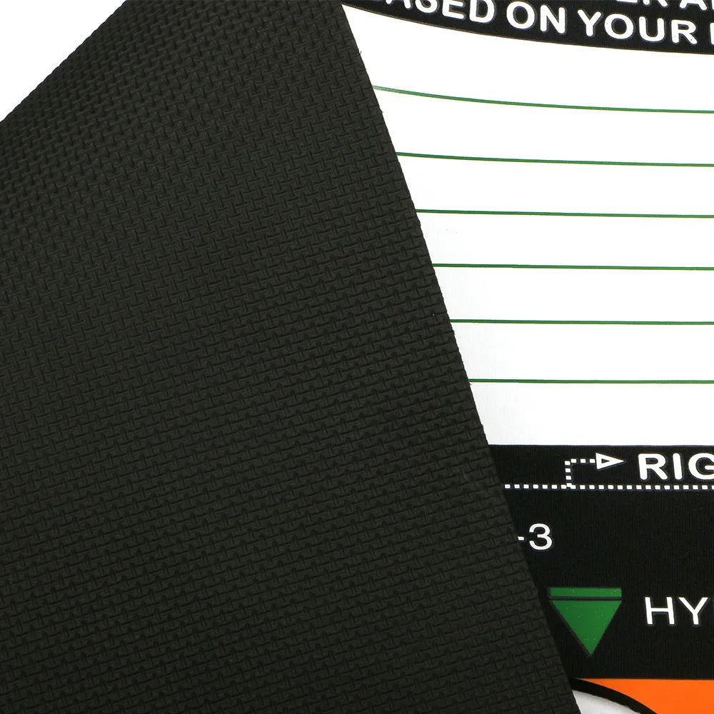Black neoprene golf swing standing posture auxiliary pad on a practice surface.