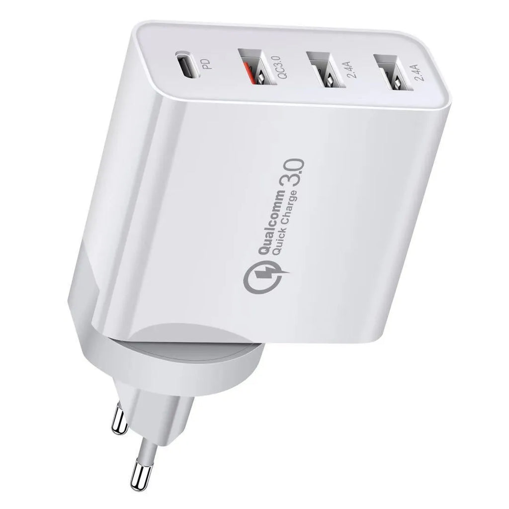 White multi-port fast charging adapter with UK plug on a table.