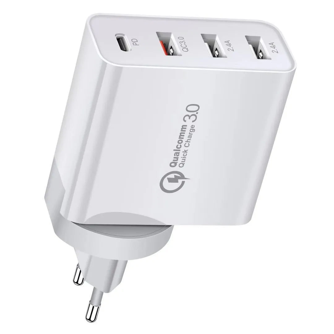 White multi-port fast charging adapter with UK plug on a table.