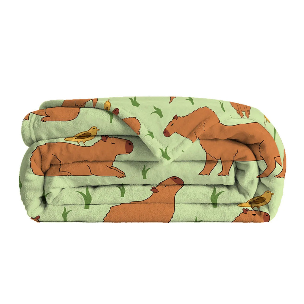 Multicolored flannel blanket with bird and capybara combined pattern on a sofa