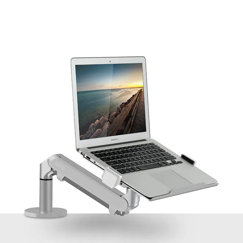 Silver aluminium alloy Free Hover laptop stand with adjustable air pressure arm on a desk.