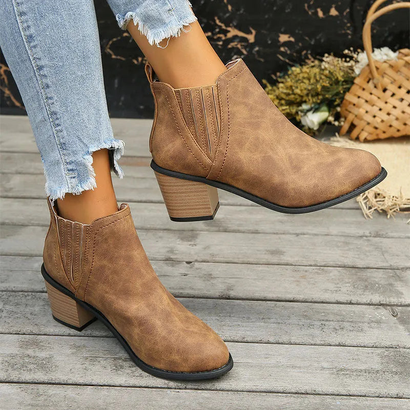 Women's black and brown pointed toe ankle boots with thick square heel and slip-on design made of artificial PU.