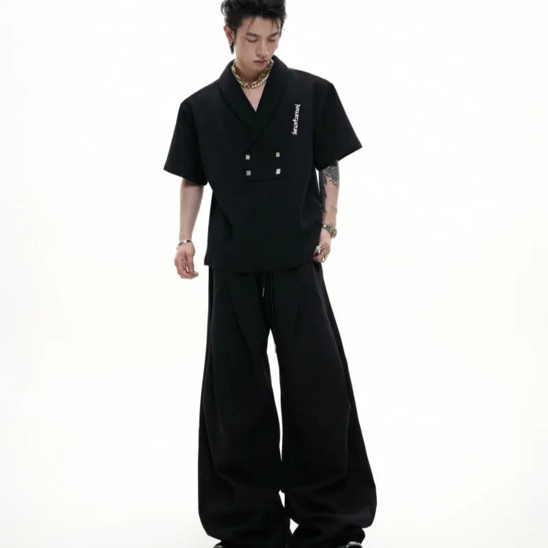 Men's dark grey cotton sports suit with V-neck short sleeve top featuring padded shoulders and metal embellishments with matching shorts