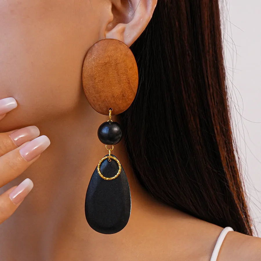 Wooden retro earrings with silver brown black colour scheme and elliptical design elements