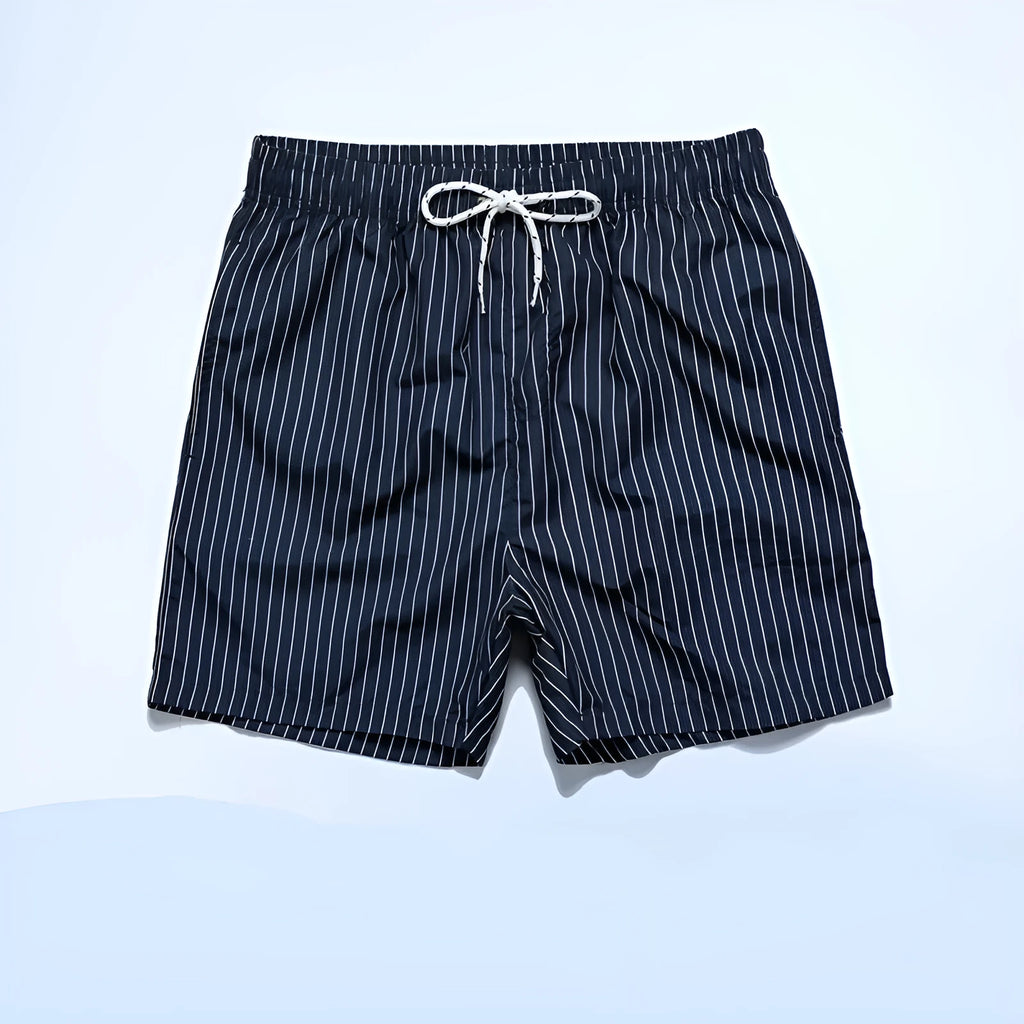 Striped polyester beach shorts in navy blue, shown with straight leg openings and triangle lining.
