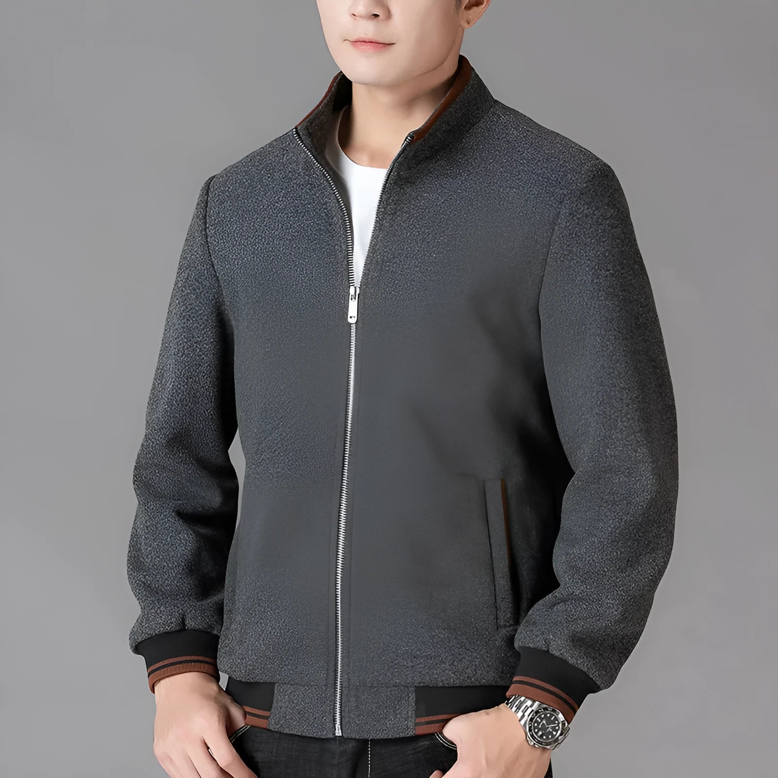 Men's grey polyester fleece jacket with zip pockets and long sleeves, shown on a hanger.