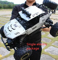 Black and silver 2.4G wireless remote control four-wheel drive car on a rough surface.