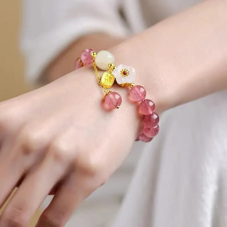 Handmade strawberry quartz crystal bracelet with a choice of moon, XINGX, or pearl charm on a natural crystal band.