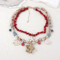 Gold marine life clavicle chain with conch shell and starfish pendant on display